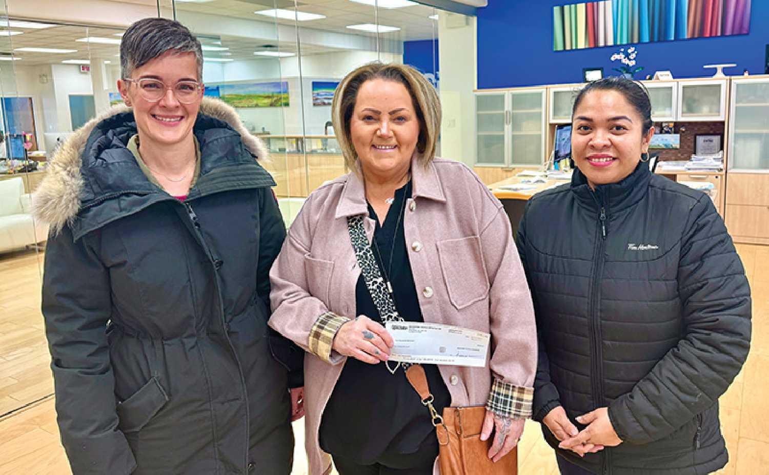 From left are Amy Leduc and Terri Lowe with Play Fair Daycare, and Cherri Caliwag from Tim Hortons with the cheque from the World-Spectator.